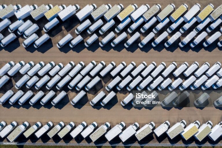 White delivery vans viewed directly from above.