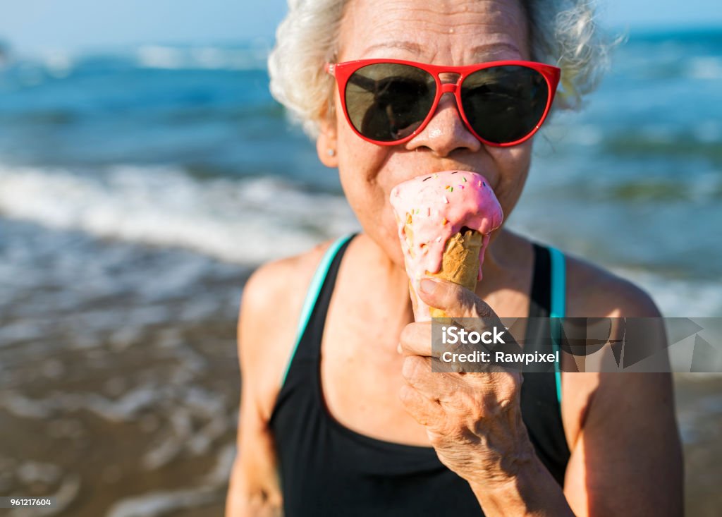 Senior woman eating an ice-cream